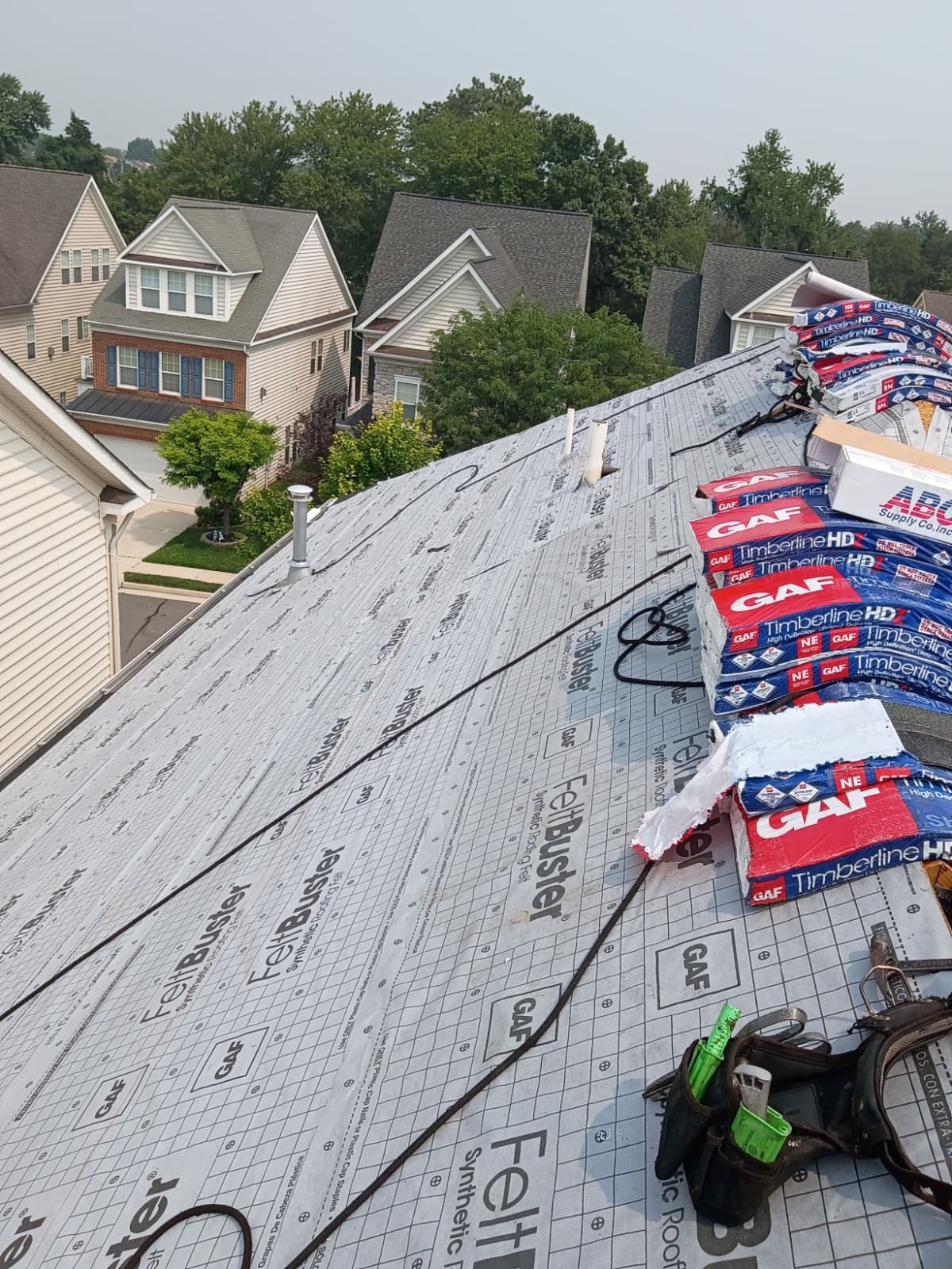 GAF underlayment and Timberline HD shingles staged during a roof installation